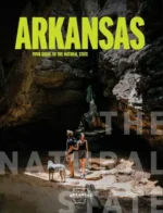 Arkansas Travel Guide: A scenic view of the Buffalo National River with high limestone bluffs and lush green forests in Arkansas.