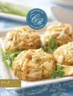 Chesapeake Bay Crab Cakes Catalog: A collection of golden-brown Chesapeake Bay crab cakes served on a platter with lemon wedges and fresh parsley.