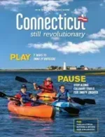 Connecticut Travel Guide: A scenic view of a historic lighthouse on the Connecticut coast during sunset.