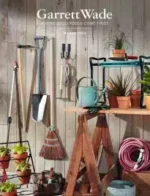 Garrett Wade Catalog: A collection of high-quality woodworking hand tools and garden implements arranged neatly on a wooden workbench.