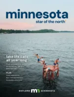 Minnesota Travel Guide: Aerial view of a scenic Minnesota lake surrounded by lush green forests during summer.