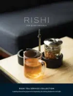Rishi Tea Catalog: Close up of high-quality loose leaf green tea and dried botanicals on a wooden surface