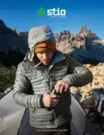 Stio Outdoor Apparel Catalog: A collection of technical outdoor jackets and mountain apparel displayed against a rugged landscape background.